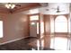 Open living area with a ceiling fan, tile and wood flooring, and large windows at 128 Golf Course St, Las Vegas, NV 89145
