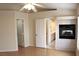The main bedroom includes a fireplace, ceiling fan and attached bathroom and doorway to another room at 128 Golf Course St, Las Vegas, NV 89145