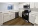 Beautiful kitchen with white cabinets, stainless steel appliances, and hardwood floors, flowing to a bright living space at 1405 S Nellis Blvd # 2087, Las Vegas, NV 89104