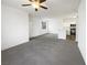 Bright living room featuring plush gray carpet, white walls, and an open layout into the kitchen at 1405 S Nellis Blvd # 2087, Las Vegas, NV 89104