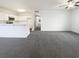 Bright open-concept living space featuring neutral walls, carpet, and a ceiling fan for comfortable living at 1405 S Nellis Blvd # 2087, Las Vegas, NV 89104