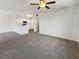 A well lit living room with neutral colored walls and gray carpet leads into the open concept kitchen at 1405 S Nellis Blvd # 2087, Las Vegas, NV 89104
