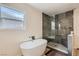 Stylish bathroom with a standalone tub, glass shower enclosure, and updated fixtures at 1712 Chapman Dr, Las Vegas, NV 89104