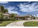 Charming single-story home featuring a covered carport, mature landscaping, and a circular driveway at 1712 Chapman Dr, Las Vegas, NV 89104