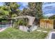 Backyard garden with a canopy, raised beds, and lush greenery near the pool at 1712 Chapman Dr, Las Vegas, NV 89104