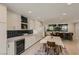 Bright eat-in kitchen with wine fridge and views of the dining area with backyard access at 1712 Chapman Dr, Las Vegas, NV 89104