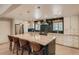 Bright eat-in kitchen with large marble island, stainless steel appliances, and green tile backsplash at 1712 Chapman Dr, Las Vegas, NV 89104