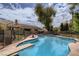 Inviting backyard pool with diving board, surrounded by well-maintained landscaping and secure fencing at 1712 Chapman Dr, Las Vegas, NV 89104