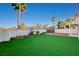 A well-maintained backyard with a storage shed, artificial grass, and brick patio at 1800 Summit Pointe Dr, Las Vegas, NV 89117