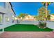 Lush artificial grass and brick patio highlight this landscaped backyard at 1800 Summit Pointe Dr, Las Vegas, NV 89117