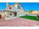 A spacious backyard boasts manicured lawn and a covered patio for outdoor enjoyment at 1800 Summit Pointe Dr, Las Vegas, NV 89117