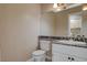 A pristine bathroom featuring a granite countertop and a stylish mirror at 1800 Summit Pointe Dr, Las Vegas, NV 89117
