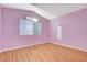 Bedroom with laminate wood flooring, neutral walls, and a large window for natural light at 1800 Summit Pointe Dr, Las Vegas, NV 89117