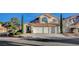 Charming two-story home with a well-manicured front yard and three-car garage at 1800 Summit Pointe Dr, Las Vegas, NV 89117