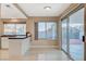 Kitchen features a large window, tile countertops, and sliding glass doors to the backyard patio at 1800 Summit Pointe Dr, Las Vegas, NV 89117