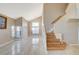 Living room with vaulted ceilings, large windows, and wood staircase at 1800 Summit Pointe Dr, Las Vegas, NV 89117