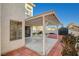 A covered patio seating area for outdoor entertainment, lush lawn and storage shed at 1800 Summit Pointe Dr, Las Vegas, NV 89117