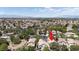 An aerial view displays a suburban home in a lushly treed neighborhood with Las Vegas in the distance at 1861 Windward Ct, Henderson, NV 89012