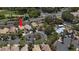 An aerial view shows a home in a landscaped neighborhood with a community pool and easy access to main roads at 1861 Windward Ct, Henderson, NV 89012