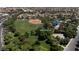 An aerial view features Paseo Verde Park, a landscaped green space with trees and baseball diamond at 1861 Windward Ct, Henderson, NV 89012