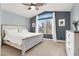 This bedroom features a ceiling fan, a bed with white linens, and a beautiful nature view from the window at 1861 Windward Ct, Henderson, NV 89012