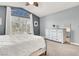 This cozy bedroom features a ceiling fan, a bed with white linens, and a chest of drawers at 1861 Windward Ct, Henderson, NV 89012