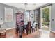 Cozy dining room featuring a dark wood table, china cabinet, and sliding glass doors to the backyard at 1861 Windward Ct, Henderson, NV 89012