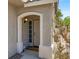 Inviting front entrance with security door, neutral tones and decorative stone accents at 1861 Windward Ct, Henderson, NV 89012