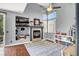 Cozy living room with a charming fireplace, natural light, and decorative shelving at 1861 Windward Ct, Henderson, NV 89012