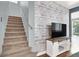 Living room with stairs and modern entertainment center, creating a cozy and inviting atmosphere at 1861 Windward Ct, Henderson, NV 89012