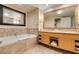Large bathroom featuring double sinks and a separate soaking tub with marble surround at 2000 Fashion Show Dr # 5509, Las Vegas, NV 89109
