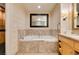 Large bathroom featuring double sinks and a separate soaking tub with marble surround at 2000 Fashion Show Dr # 5509, Las Vegas, NV 89109
