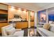 A well-appointed living room with a kitchenette, sofa, and comfortable seating with city views at 2000 Fashion Show Dr # 5509, Las Vegas, NV 89109