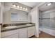 Well-lit bathroom with double sink vanity and tiled shower/tub combo at 2017 Plaza De Cielo, Las Vegas, NV 89102