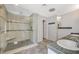 Modern bathroom featuring a glass enclosed shower, built-in bench, and dual sinks at 2017 Plaza De Cielo, Las Vegas, NV 89102