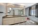 Bright bathroom featuring a double sink vanity, granite countertops, and a spacious glass-enclosed shower at 2017 Plaza De Cielo, Las Vegas, NV 89102