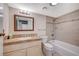 Cozy bathroom features a shower-tub combo with neutral tile, single sink vanity, and decorative mirror at 2017 Plaza De Cielo, Las Vegas, NV 89102