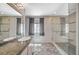 Modern bathroom featuring a glass-enclosed shower, built-in bench, and a large window for natural light at 2017 Plaza De Cielo, Las Vegas, NV 89102