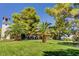 Beautifully landscaped community grounds with mature trees, palm trees, and a bell tower at 2017 Plaza De Cielo, Las Vegas, NV 89102