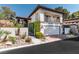 Two-story home featuring a tile roof, balcony, and a well-maintained front yard with mature landscaping at 2017 Plaza De Cielo, Las Vegas, NV 89102