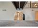 Bright living room with wood beam ceiling, arched doorway, and gray carpet at 2017 Plaza De Cielo, Las Vegas, NV 89102