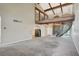 Expansive living room with high ceilings, exposed beams, a staircase, and an arched doorway at 2017 Plaza De Cielo, Las Vegas, NV 89102