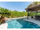 Beautiful pool area features mature landscaping, a rock waterfall, and covered patio for relaxing and entertaining at 2017 Plaza De Cielo, Las Vegas, NV 89102