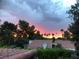 Beautiful sunset view over lush landscaping and red tile roofs, adding serenity and charm at 2017 Plaza De Cielo, Las Vegas, NV 89102