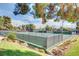 Multiple outdoor tennis courts surrounded by lush greenery in a gated community at 2017 Plaza De Cielo, Las Vegas, NV 89102