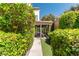 Charming walkway leads to the home's entrance, bordered by lush, green landscaping and mature plants at 2017 Plaza De Cielo, Las Vegas, NV 89102