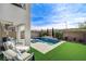 Backyard featuring a pool with spa, covered patio, manicured lawn, and a private, relaxing retreat at 2115 Noble Perch St, Las Vegas, NV 89138