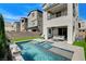 Private backyard features a sparkling pool, patio area, and lush landscaping at 2115 Noble Perch St, Las Vegas, NV 89138