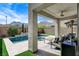 Backyard boasts a covered patio and private pool with a spa and mountain views at 2115 Noble Perch St, Las Vegas, NV 89138