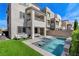 Backyard showcases a modern pool with spa, turf, and outdoor seating, perfect for entertaining at 2115 Noble Perch St, Las Vegas, NV 89138